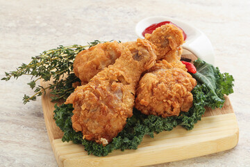 Fried chicken drumsticks with tomato sauce