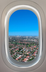 Airplane window view of Sydney NSW Australia. Residential and commercial houses from above 