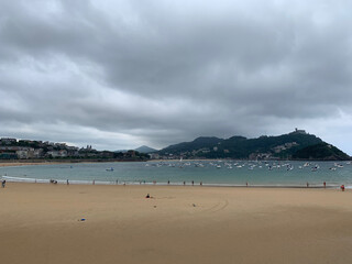 Fototapeta na wymiar People enjoying summer day at San Sebastian beach La Concha in Basque Country