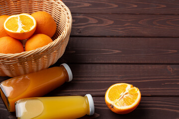 Fresh orange juice in the glass with orange fruit on wooden background