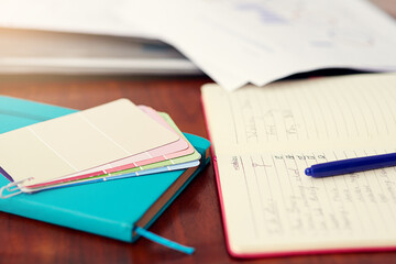 Your business survival kit. Shot of color swatches and an open notebook on an office desk.