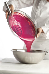 Pouring melted ruby chocolate cooking with a melted ruby chocolate bowl. making ruby chocolate 