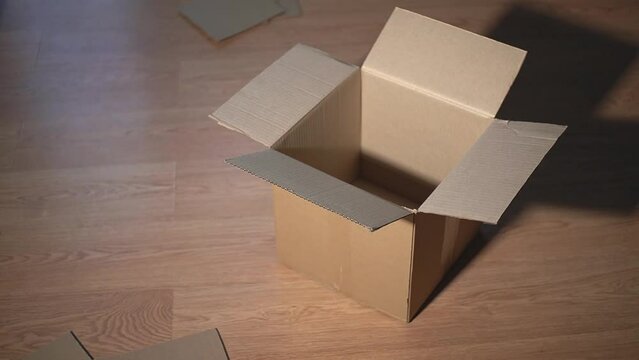 cardboard falls into a cardboard box