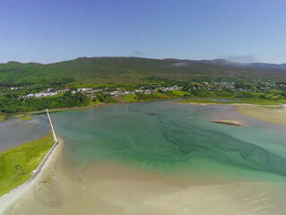 Beautiful ocean and beach. Mulranny town in the background. Warm sunny day. Blue sky. Aerial view. Irish landscape