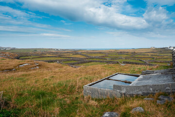 Obraz premium Nature scene of Inishmore,, Aran island. Rough stone terrain. Blue cloudy sky. Maze of dry stone walls. Popular tourist area with amazing nature view.