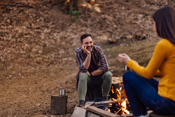 Fototapeta premium Smiling man looking at his female lover, talking to each other, spending time outdoor.