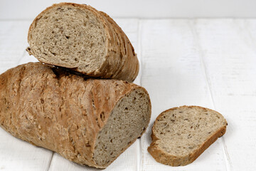 Homemade sliced bread on white rustic wooden table 