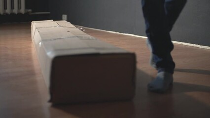 a man walks around his parcel while waiting