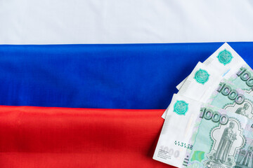 Russian ruble banknotes on russian flag