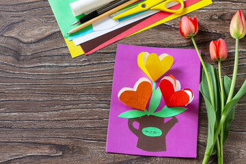 Greeting card Mother's Day with bouquet flowers tulips with the inscription of Mom. Children's art project, craft for children. Handmade. Craft for kids. Copy space.