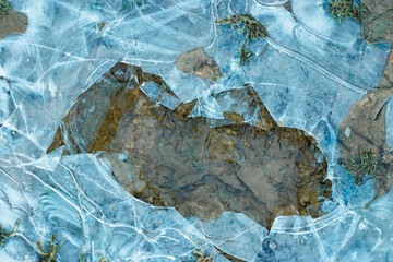 Pieces of ice in nature. Chunks of cracked ice closeup. Broken ice on the lake. Pieces of ice close up.