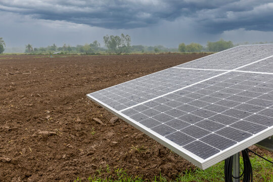 Photovoltaic solar energy panels in farm on the rainy seasons. Water raindrops on cell glass