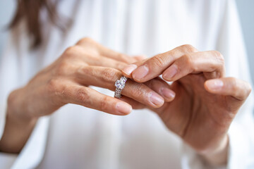 Close up of decisive woman take off wedding ring make decision breaking up with husband, young...