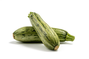 Fresh cut zucchini isolated on a white background with clipping path. Design element for product label. Design image of fresh whole zucchini. Green zucchini vegetables isolated on white.
