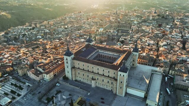 Aerial view of Toledo, Castilla-La Mancha, Spain. Flight over houses and cathedral in Toledo at sunset