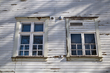 Old windows in weathered wooden wall exterior
