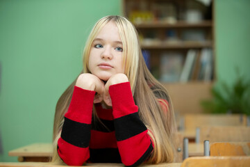 Teenager of senior school age. Teenage girl at the desk.