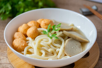 Udon, Shrimp Balls, and Fish Balls in Clear Soup Japanese Cuisine in a white porcelain cup