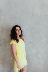 Naklejka premium beautiful woman in a yellow summer dress