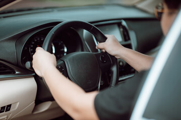 Naklejka premium Asian man driving a car on the road. Driving car concept.