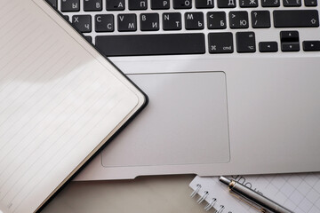 Working office table. On the table is a diary, a workbook, a pen.