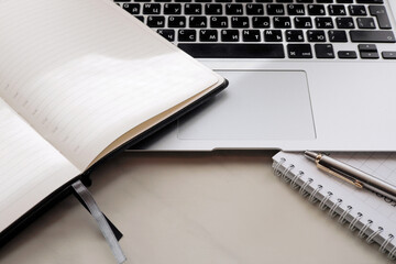 Working office table. On the table is a diary, a workbook, a pen.