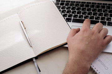 An office worker works on a laptop in the office.