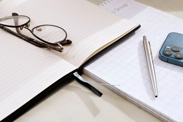 Home Office. On the table are glasses, a diary, a workbook.