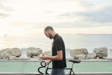 Bearded man with bicycle at pier