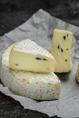 mild blue cheese. cambozola cheese, German creamy blue brie Cambozola soft cheese with blue mould close up. french cuisine. vertical image. top view. place for text.