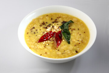 Indian food tuvar Daal or yellow lentil soup or curry in  ceramic bowl  