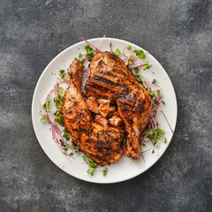 Two chicken legs grilled with garlic on a white plate. Top view, above. Flat lay - 497457520