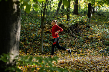 Young woman running in park.