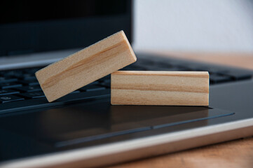 Blank wooden blocks on top of a laptop. Copy space concept
