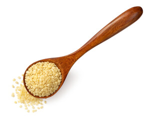 Raw hemp seeds in the wooden spoon, isolated on the white background, top view.