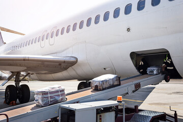 Loading luggage on the plane. The baggage on the conveyor belt to the airplane.