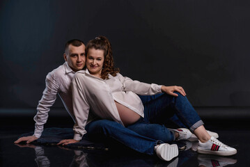 studio portraits of a couple expecting a baby