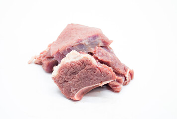 close up, fresh Pile of beef cubes isolated on white.