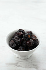 Ajwa Dates on White Bowl,