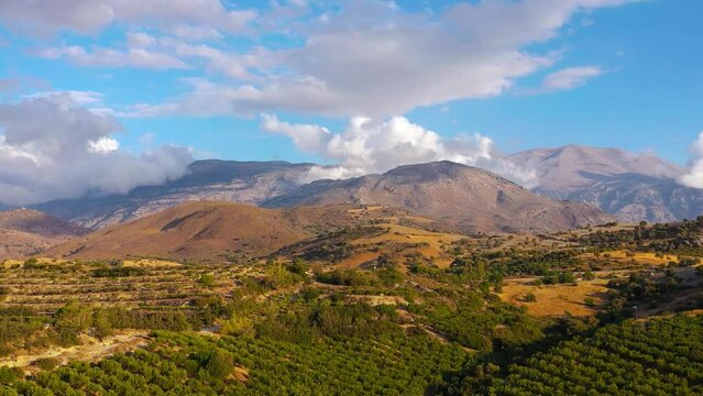 Aerial view of Crete island, Greece. Mountain landscape, olive groves and vineyards at sunset.