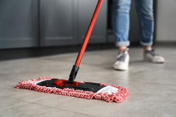 Close up of caucasian woman mopping the floor at home