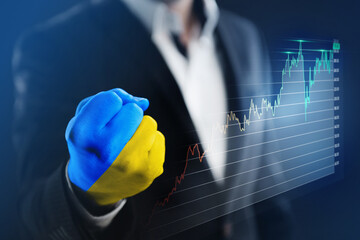 the businessman clenched his hand painted in the colors of the Ukrainian flag into a fist. The concept of assistance and economic growth with the help of the countries of the European Union
