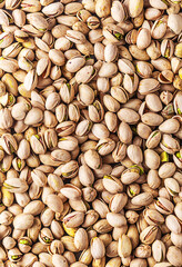 Pistachios seeds texture, top view, vertical. It has high levels of unsaturated fatty acids and potassium