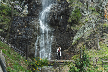 Fototapeta premium 滝のそばにいる女性