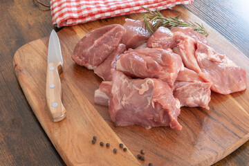 pieces of raw pork meat isolated on a wooden board