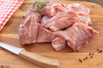 pieces of raw pork meat isolated on a wooden board