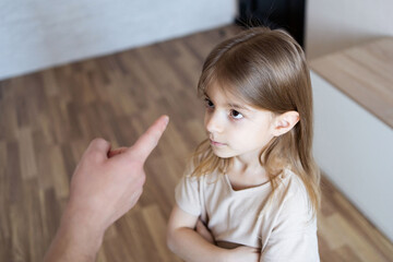 Negative emotion parent pointing at child , problem at home. Father punishing his child, domestic...