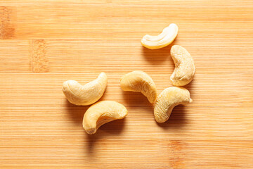 Cashew at wooden background . Anacardium occidentale seeds 