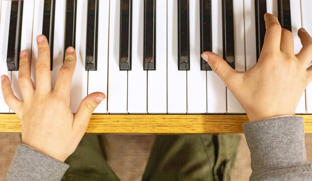 happy young pianist playing piano waltz with two hands, Flatlay