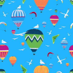 Seamless pattern with hot air balloons, paragliders and hang glider and seagulls on a bright blue background.
